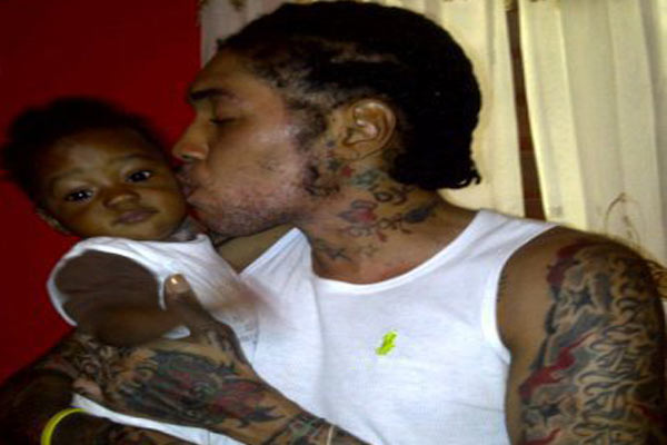 Photo of Vybz Kartel Kissing his kid
