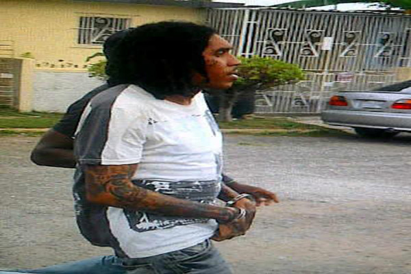 photo of Vybz Kartel handcuffed and arrested